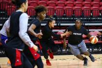 Dreu Johnson, right, drives the ball under pressure from Las Vegas Aces' Kayla McBride during p ...