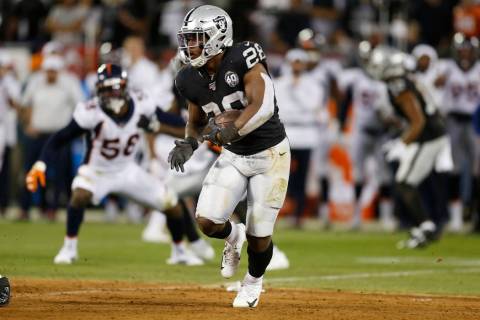 Oakland Raiders running back Josh Jacobs runs with the ball during the first half of an NFL foo ...