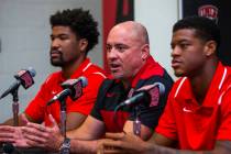 UNLV football head coach Tony Sanchez, center, answers a media question beside quarterback Arma ...