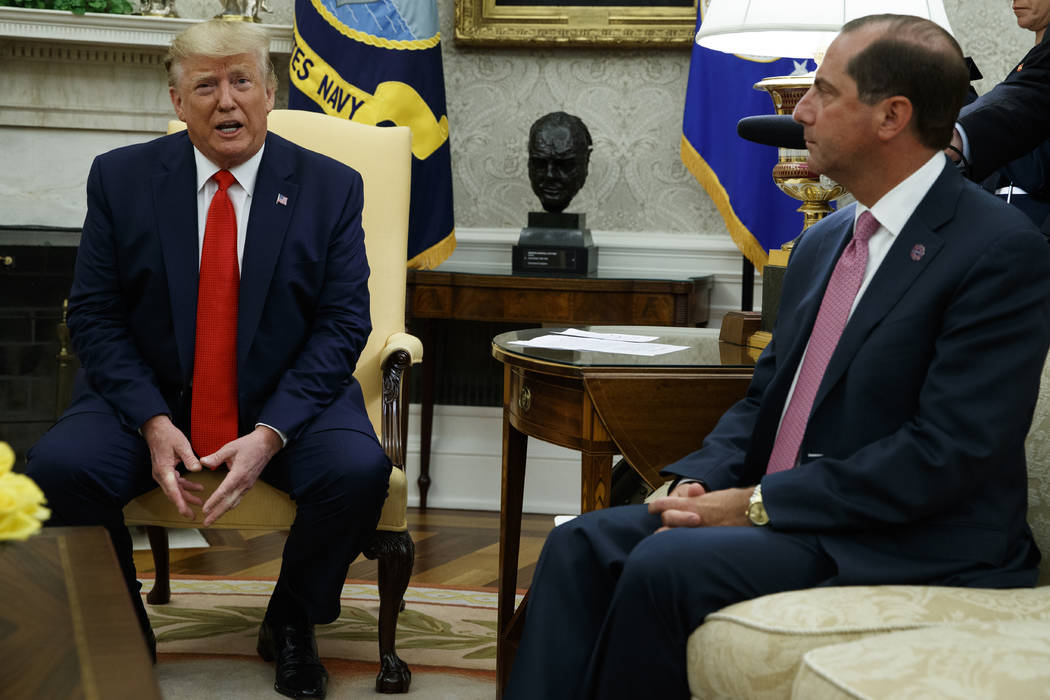 Secretary of Health and Human Services Alex Azar looks on as President Donald Trump talks about ...