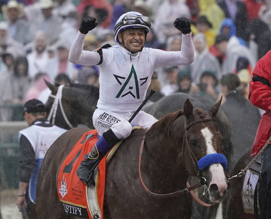 Mike Smith celebrates after riding Justify to victory during the 144th running of the Kentucky ...