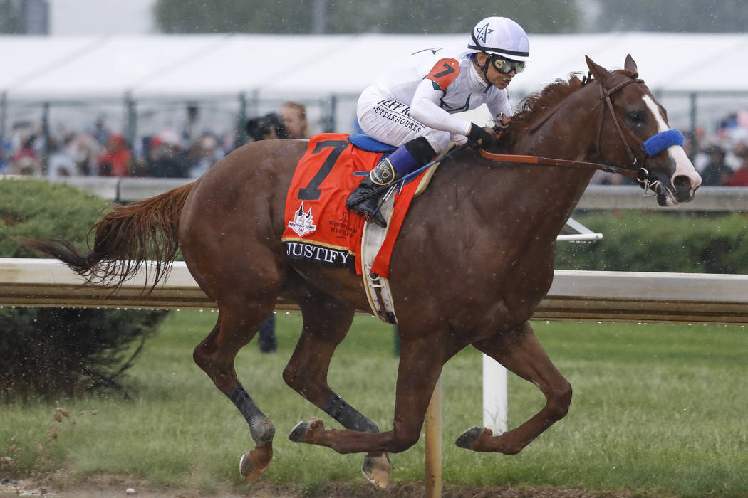 Mike Smith rides Justify through the fourth turn and unto victory during the 144th running of t ...