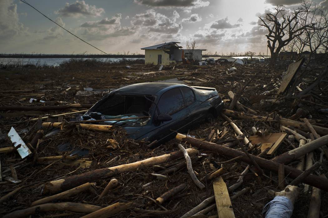 A car is sunk in the wreckage and debris caused by Hurricane Dorian, in Mclean's Town, Grand Ba ...
