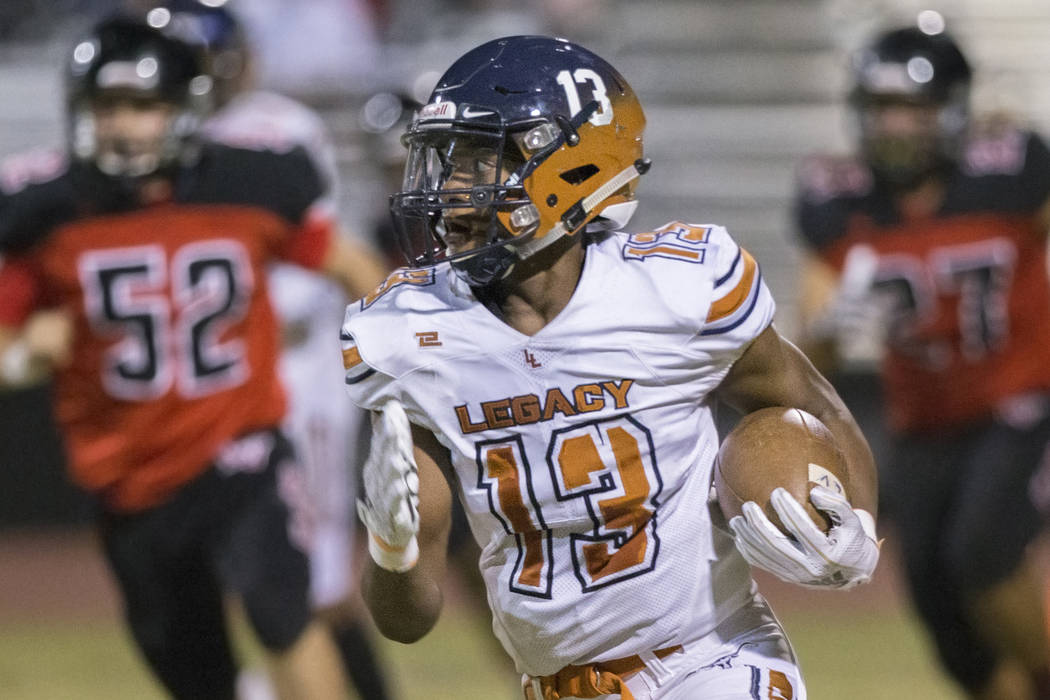 Legacy sophomore wide receiver Aaron Holloway (13) breaks into the open field past Las Vegas de ...