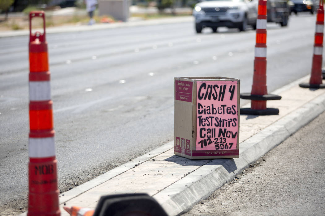 A box offering cash for diabetes testing strips is seen on West Cheyenne Avenue and North Marti ...