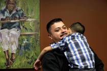 FILE - In this Friday, Oct. 17, 2014 file photo, Ignacio Lanuza-Torres holds his son, Isaiah, 4 ...