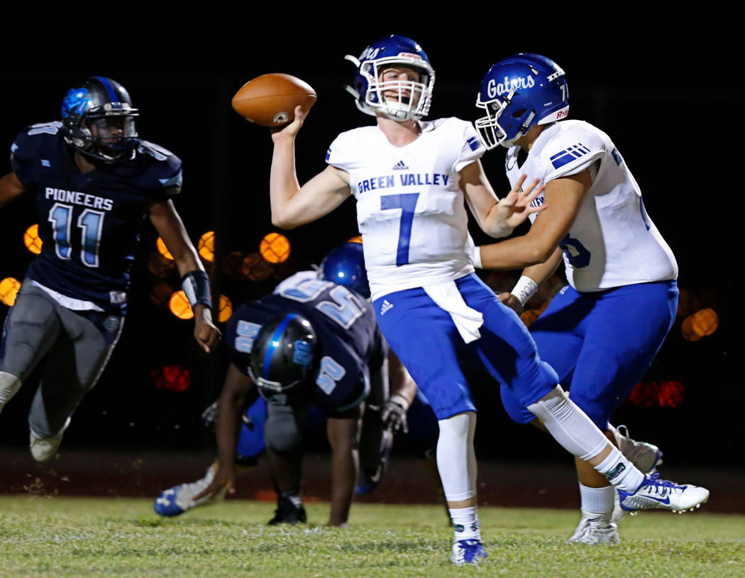 Green Valley's Garrett Castro (7) passes against Canyon Springs in the first quarter of a footb ...