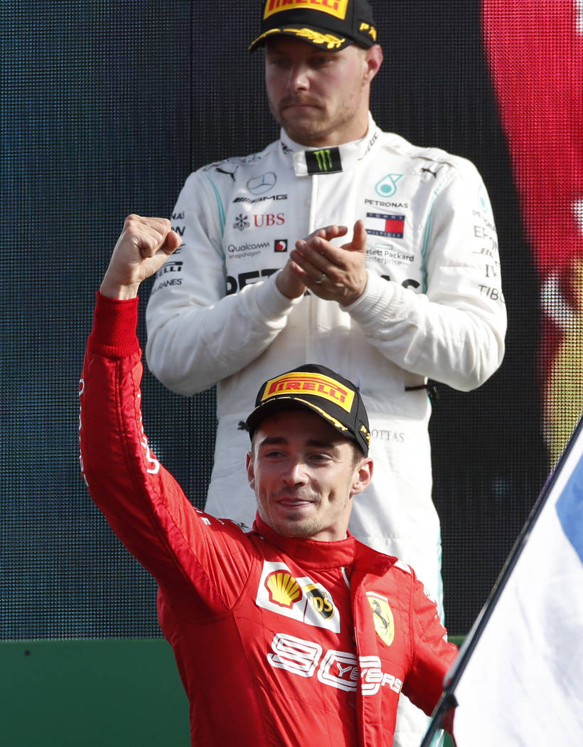 Ferrari driver Charles Leclerc of Monaco, bottom, celebrates with second placed Mercedes driver ...