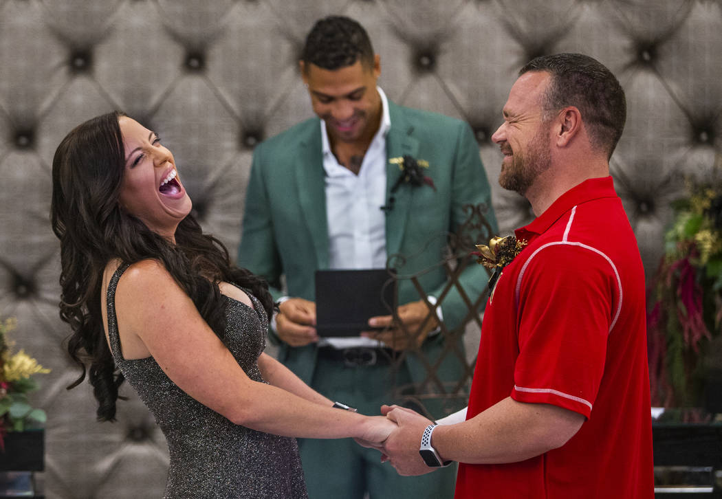 Laura and Justin Long hold hands and laugh as Vegas Golden Knights player Ryan Reaves, center, ...