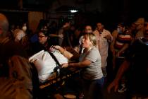 Patients are evacuated from a burning hospital in Rio de Janeiro, Brazil, Thursday, Sept. 12, 2 ...