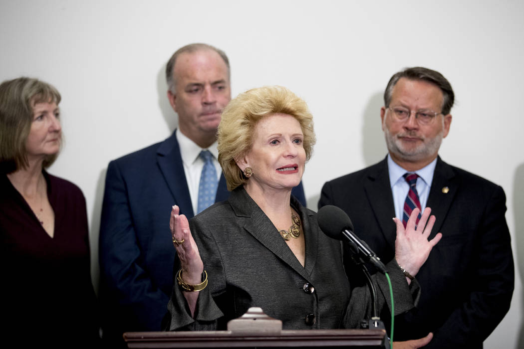 Sen. Debbie Stabenow, D-Mich., center, accompanied by Rep. Dan Kildee, D-Mich., second from lef ...