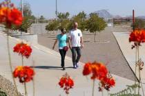 Adam Gnesia and his wife walk during a sunny morning at Cornerstone Park in Henderson. (Bizuaye ...