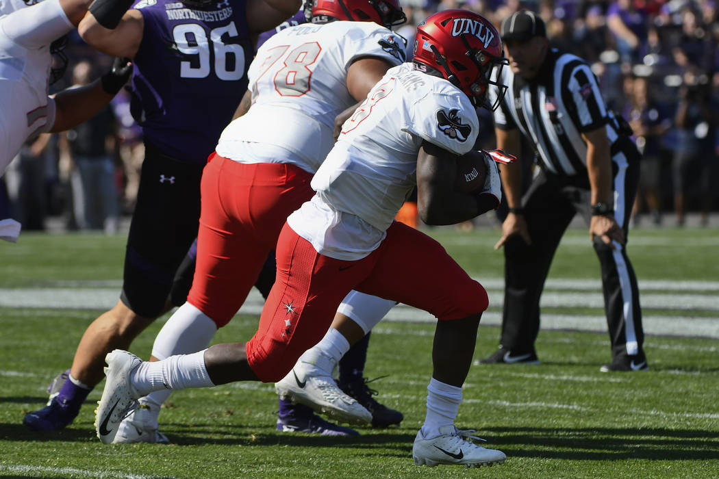 UNLV running back Charles Williams (8) runs for a touchdown against Northwestern during the fir ...
