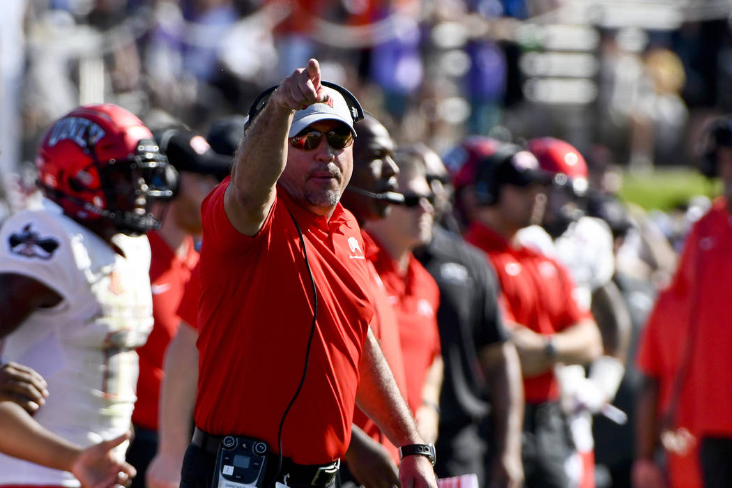 UNLV head coach Troy Sanchez works from the sideline during the first half of an NCAA college f ...