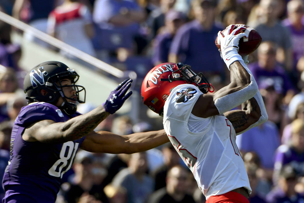 UNLV linebacker Javin White, right, intercepts a pass meant for Northwestern wide receiver Rama ...