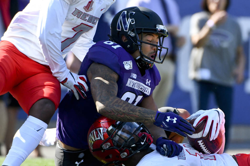 UNLV linebacker Javin White, right, intercepts a pass meant for Northwestern wide receiver Rama ...