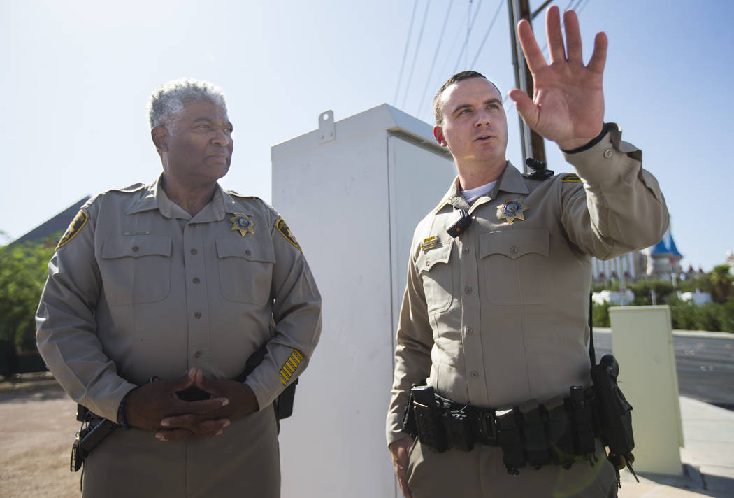 Las Vegas police officer Brandon Engstrom, right, and George Gafford, who works in the Police E ...
