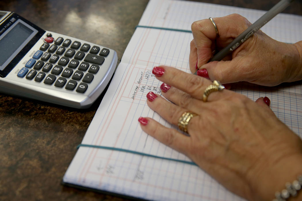 Myrna Donato, owner of Amber Unicorn Books at 2101 S. Decatur Blvd. in Las Vegas, rings up a sa ...