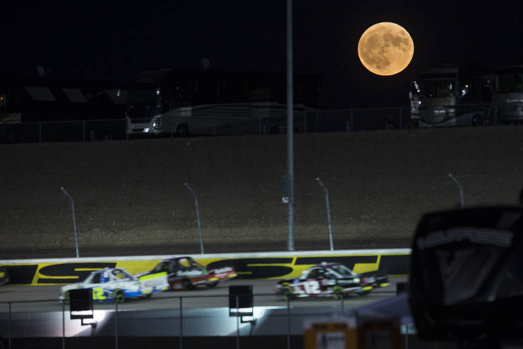 A harvest moon rises as drivers compete in the NASCAR World of Westgate 200 Truck Series auto r ...