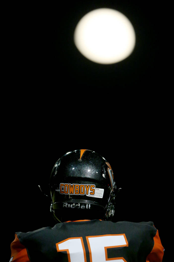 The Harvest Moon rises in front of Chaparral's Shon Williams (15) during a football game agains ...