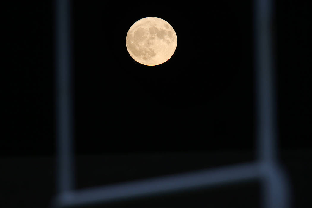 The Harvest Moon rises behind the field goal post during a game between Clark and Chaparral at ...