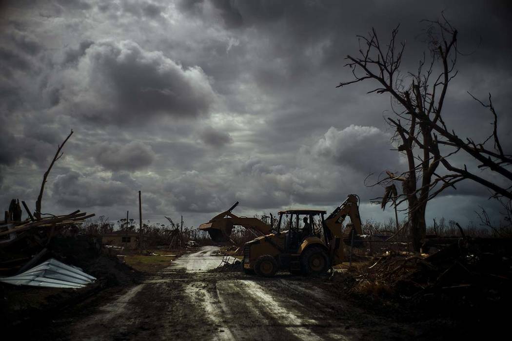 Mos Antenor, 42, drives a bulldozer while clearing the road after Hurricane Dorian Mclean's Tow ...