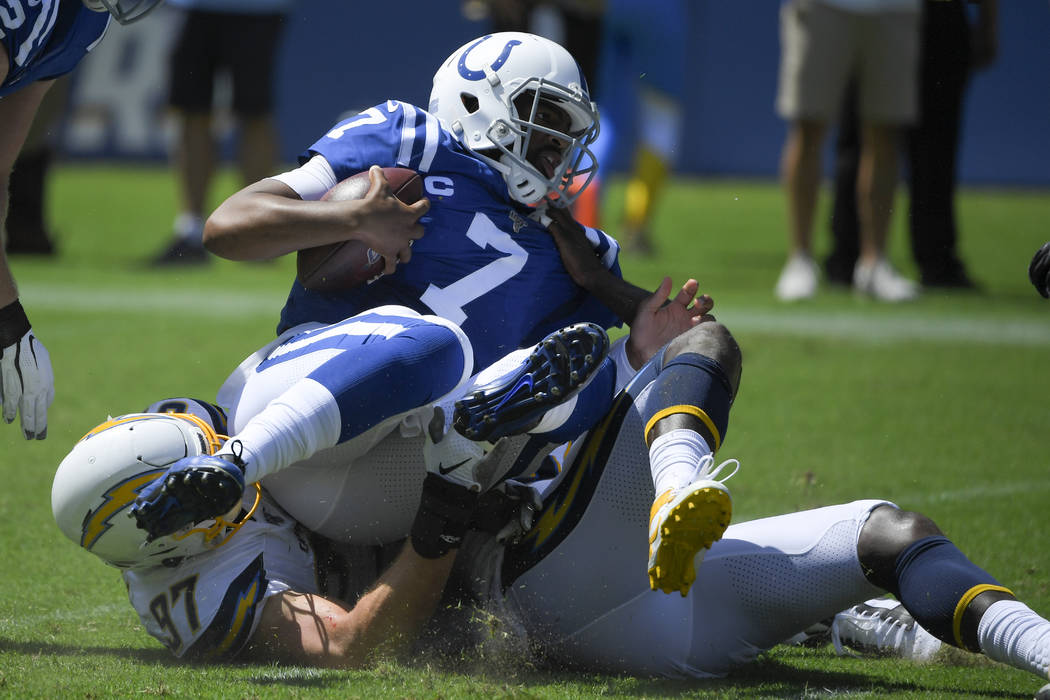 Indianapolis Colts quarterback Jacoby Brissett is sacked by Los Angeles Chargers defensive end ...