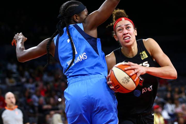 Las Vegas Aces' Dearica Hamby moves the ball around Atlanta Dream's Elizabeth Williams (1) duri ...