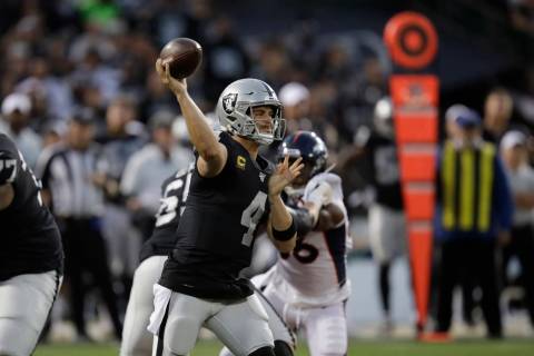 Oakland Raiders quarterback Derek Carr throws during the first half of an NFL football game aga ...