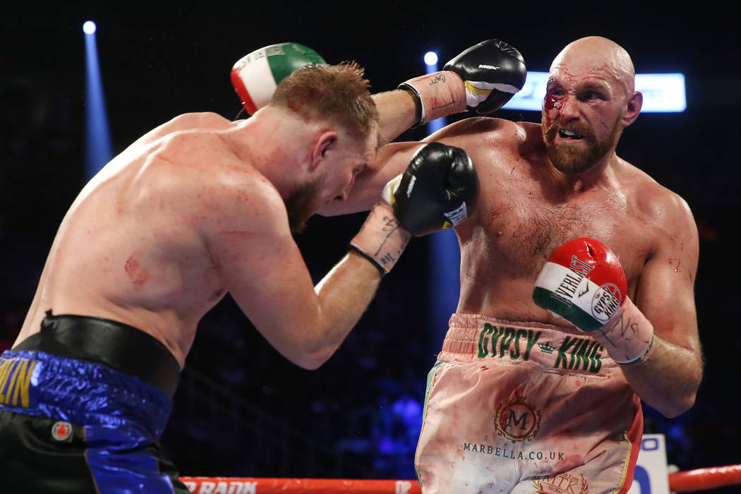 Otto Wallin, left, battles Tyson Fury in the 12th round of the heavyweight bout at T-Mobile Are ...