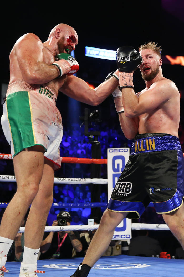 Tyson Fury, left, connects a punch against Otto Wallin in the ninth round of the heavyweight bo ...