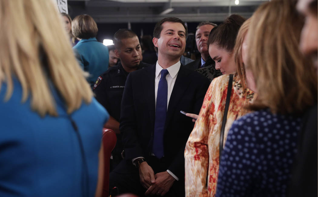 In this Sept. 12, 2019, photo, South Bend Mayor Pete Buttigieg, center, works his way through t ...