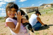 In this Tuesday, April 17, 2007 file photo, Cheyenne Yazzi hugs her puppy while her mother, Sel ...