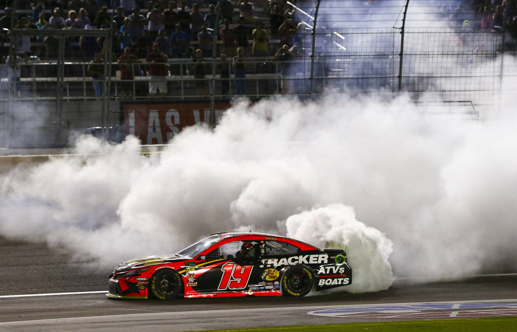 Martin Truex Jr. (19) does a burnout after winning a NASCAR Cup Series auto race at the Las Veg ...
