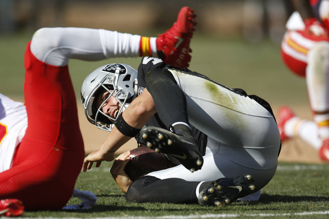 Oakland Raiders quarterback Derek Carr hits the ground after a play during the second half of a ...