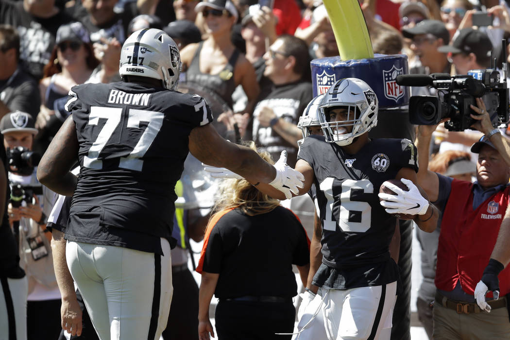 Oakland Raiders wide receiver Tyrell Williams (16) is greeted by offensive tackle Trent Brown ( ...