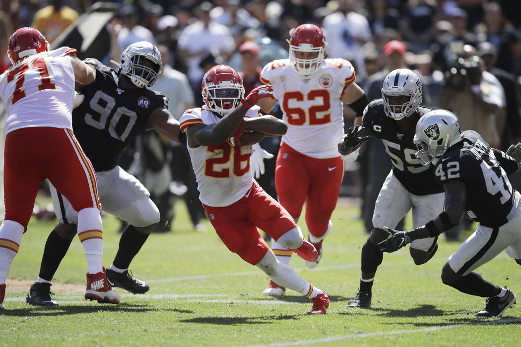 Kansas City Chiefs running back Damien Williams (26) runs with the ball during the first half o ...