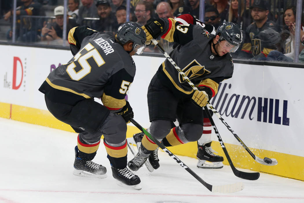 Vegas Golden Knights center Paul Cotter (43) and right wing Keegan Kolesar (55) fight for the p ...