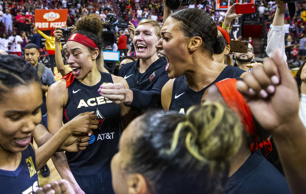 Las Vegas Aces center Liz Cambage, right, and forward Dearica Hamby, left, celebrate their 93-9 ...