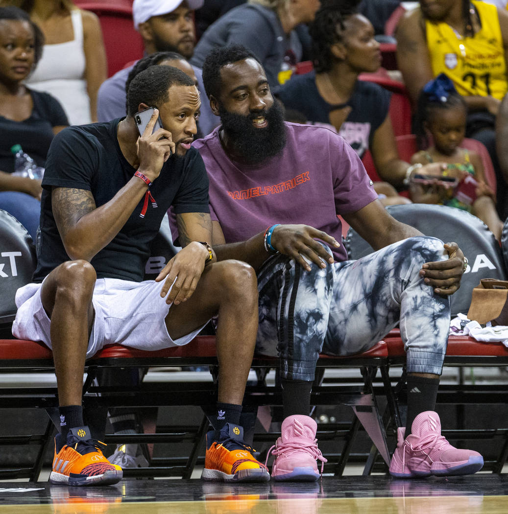 Houston Rockets player James Harden, right, enjoys the game with a companion as the Las Vegas A ...