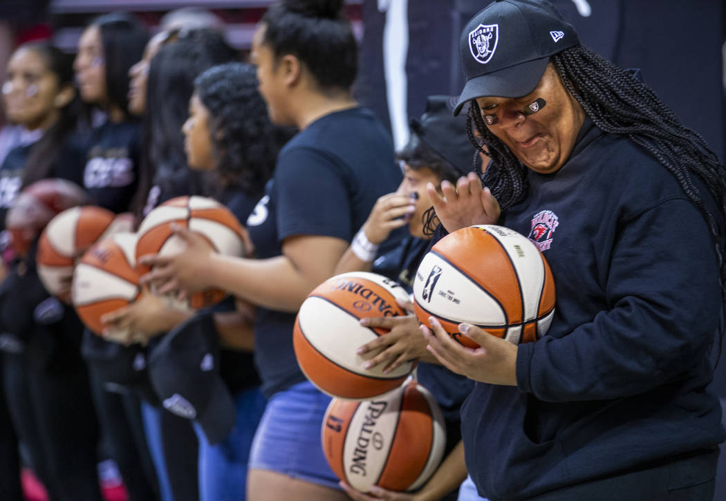 Las Vegas Aces fans are given basketballs by players prior to the first half of their WNBA play ...