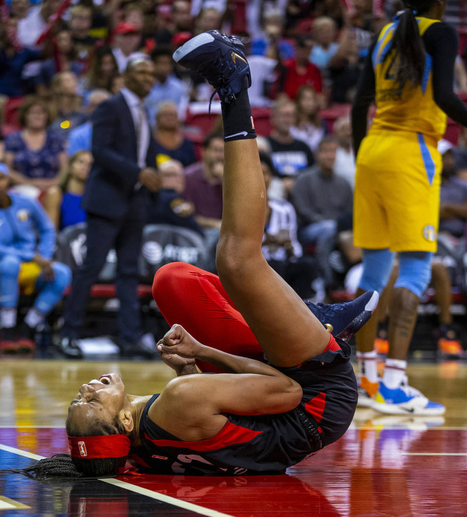 Las Vegas Aces center A'ja Wilson (22) rolls on the ground in celebration after a big shot over ...