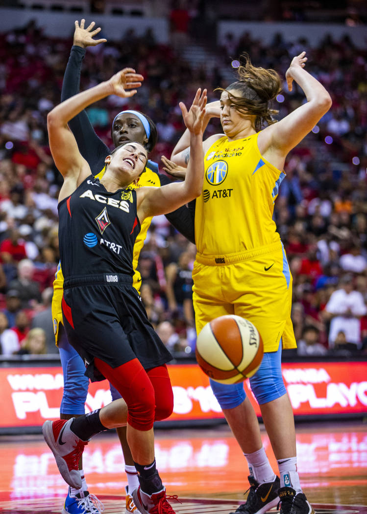 Las Vegas Aces guard Kelsey Plum (10, left) reacts to a hard shot from Chicago Sky guard Kahlea ...