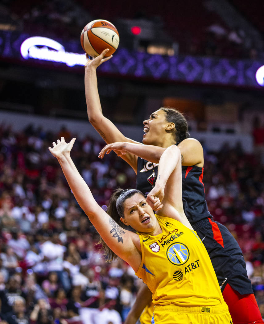 Las Vegas Aces center Liz Cambage (8, above) looks to get off a shot over the defense of Chicag ...