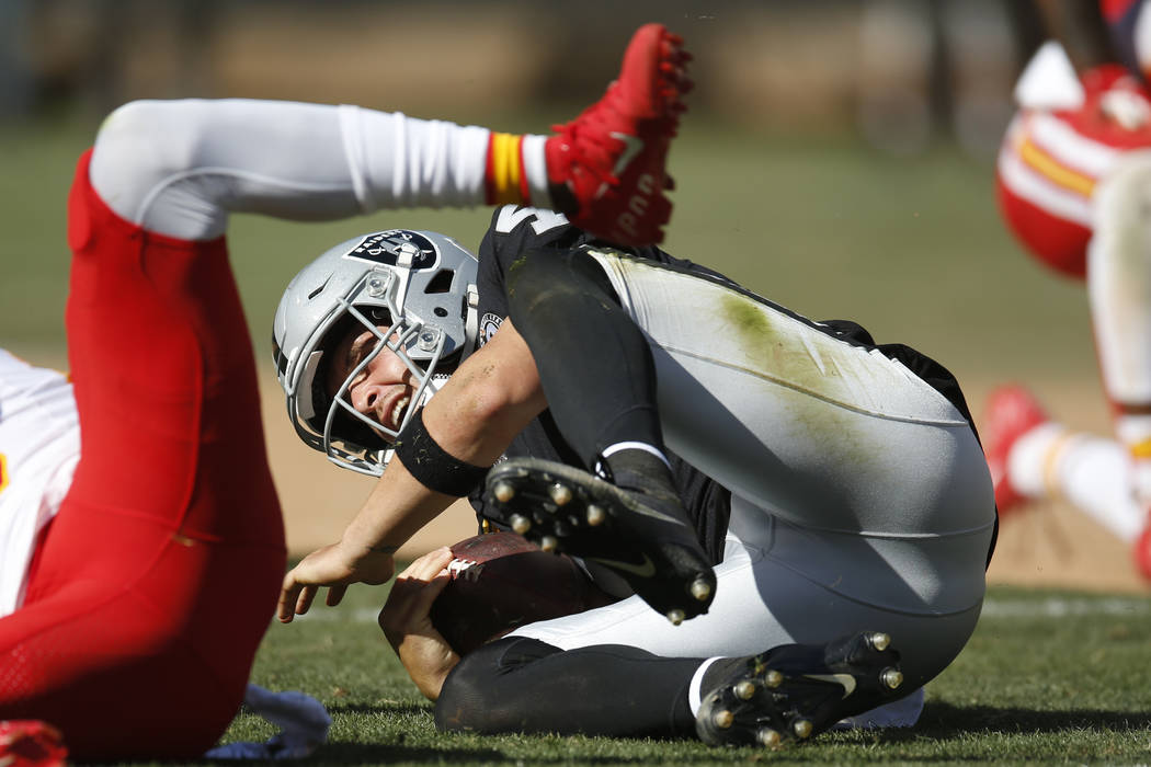 Oakland Raiders quarterback Derek Carr hits the ground after a play during the second half of a ...