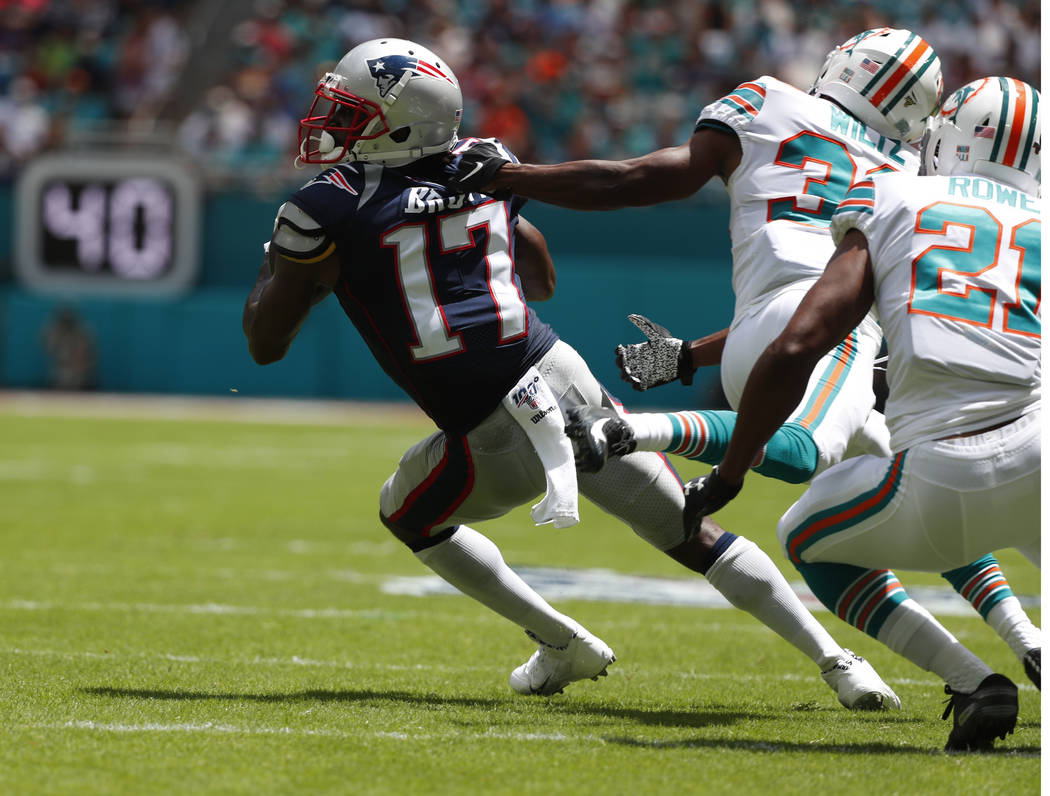 New England Patriots wide receiver Antonio Brown (17) gets away from Miami Dolphins cornerbacks ...