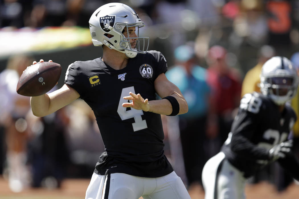 Oakland Raiders quarterback Derek Carr throws the ball during the first half of an NFL football ...