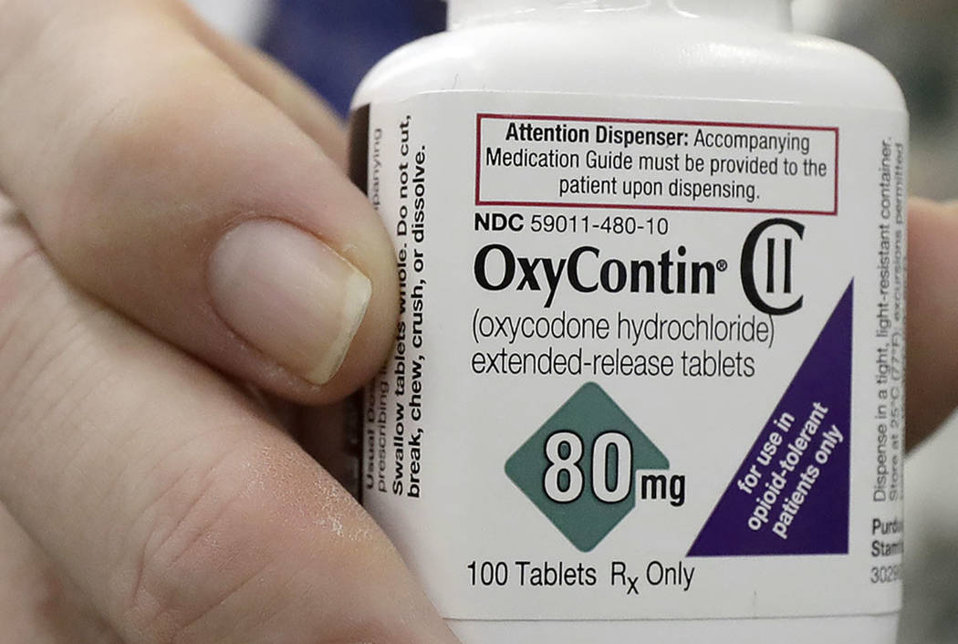 A pharmacist in San Francisco holds a bottle of OxyContin. (AP Photo/Jeff Chiu)