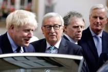 European Commission President Jean-Claude Juncker, center, speaks with British Prime Minister B ...