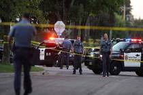 Police officers work the scene of a shooting near North Griggs and Thomas Ave West in St. Paul, ...